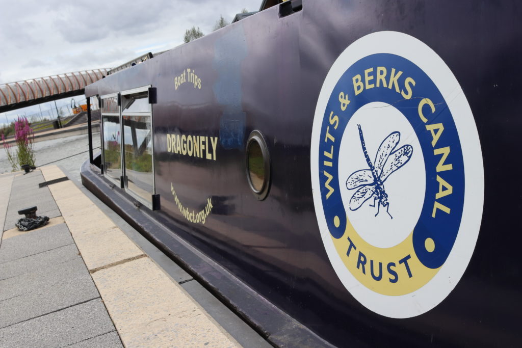 The narrowboat Dragonfly on the newly restored section of the Wilt & Berks Canal