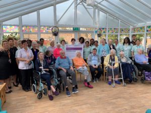 Staff and residents at Whitbourne House celebrating the CQC report
