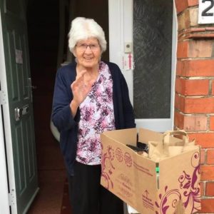 A lady receiving a food parcel