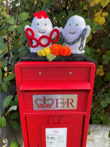 terrifying knitted ghosts on top of a postbox